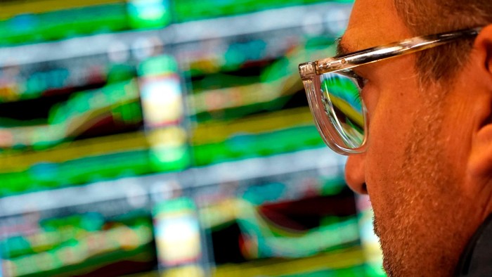 A trader works at his desk on the floor of the New York Stock Exchange